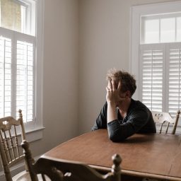Depressed man sitting at home alone.